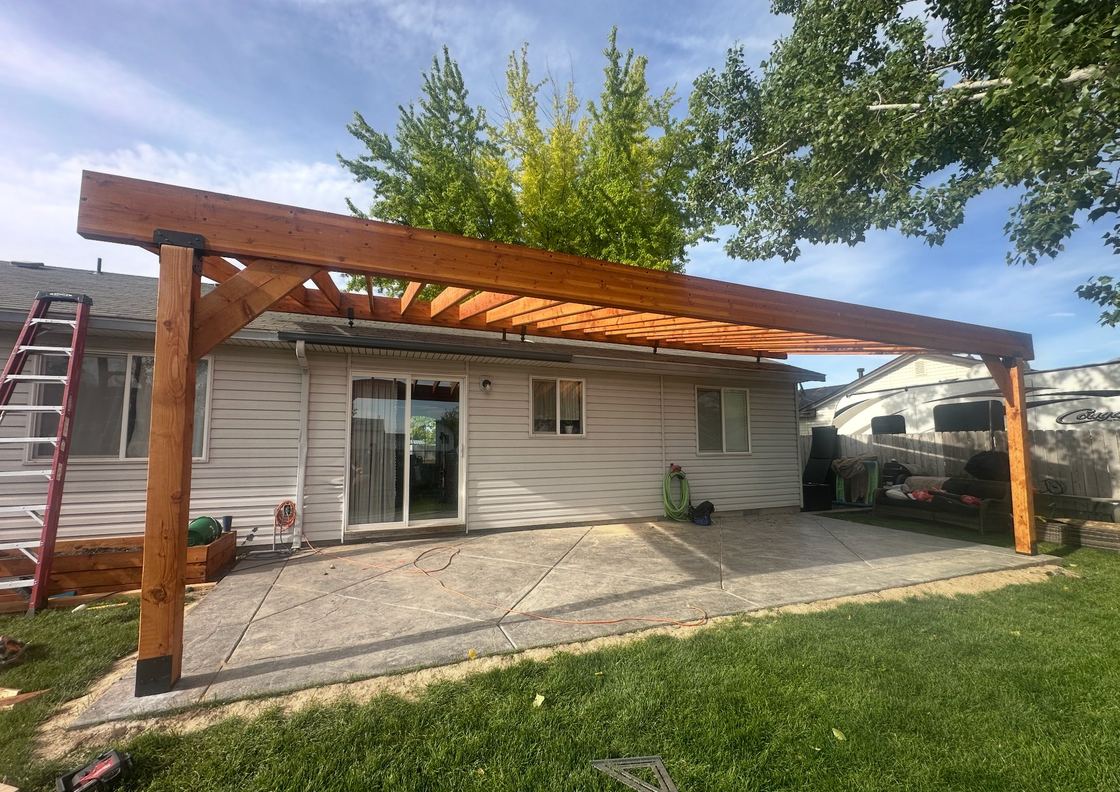 Custom cedar pergola · stamped-concrete patio