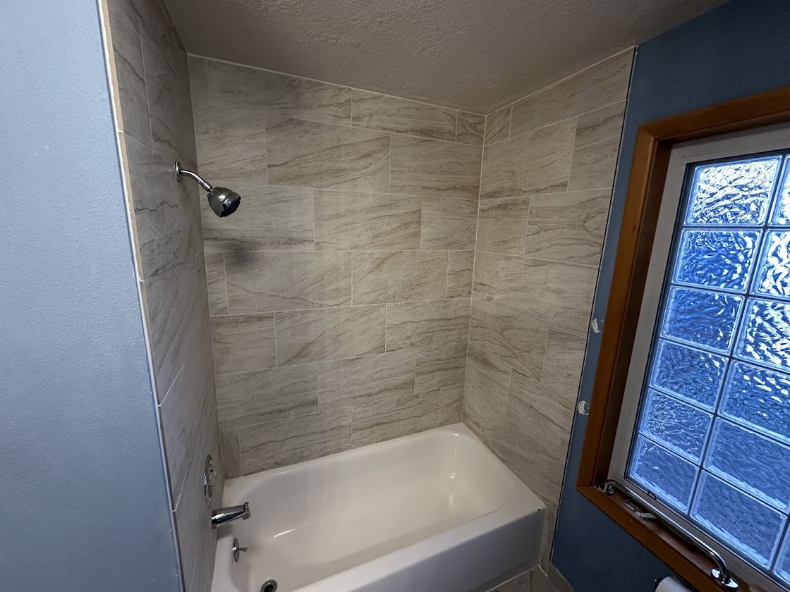 Tiled tub surround · glass-block window — custom tile by Kovo's Karpentry in Boise, Idaho